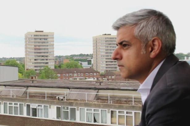 London Mayor standing on the balcony of a housing estate
